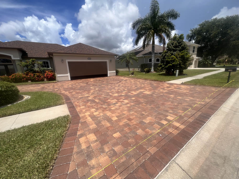 Paver driveway that looks brand new after premium paver sealer and pressure washing treatment from Stellar Clean and Seal in Brevard County