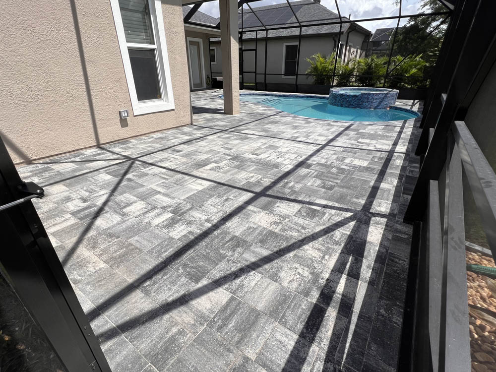 Paver pool deck that was pressure washed, sealed, and resanded by Stellar Clean and Seal in Brevard County
