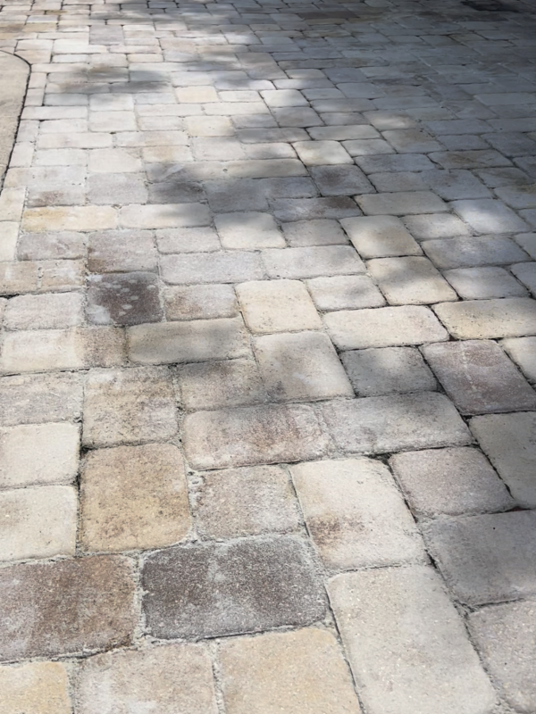 Worn and dirty paver driveway that desperately needs paver restoration from Stellar Clean and Seal in Brevard County